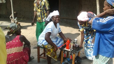 Women testing a manual oil expeller