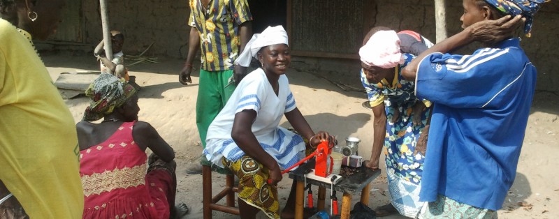Women testing a manual oil expeller