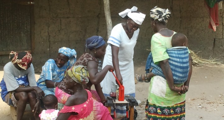 Women testing oil expeller